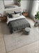 7' x 7' Square Ivory & Gray Distressed Abstract Modern Area Rug placed beneath a modern bed in a serene bedroom.