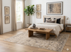 7' x 7' Square Ivory Gray Distressed Medallion Vintage Area Rug placed under a bed in a serene bedroom with layered ivory bedding and warm wood furnishings.