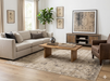 7' x 7' Square Ivory Gray Distressed Medallion Vintage Area Rug styled in a bright living room with a neutral sectional sofa, leather accent chair, and natural wood coffee table.