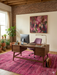 7' x 7' Square Pink Magenta Abstract Modern Area Rug styled in a home office with modern wood furniture.