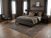 7' x 7' Square Taupe Gray Distressed Medallion Vintage Area Rug placed under a bed in a moody contemporary bedroom with charcoal bedding and dark wood furniture.