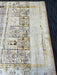 7' x 9' Rectangular Ivory & Gold Tribal Geometric Traditional Area Rug isolated on a white background.
