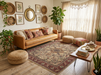 7' x 9' Rectangular Ivory & Red Floral Medallion Traditional Area Rug styled in a cozy bohemian living room.