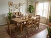 7' x 9' Rectangular Ivory & Red Floral Medallion Traditional Area Rug styled under a rustic dining table in a traditional dining room.
