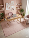 7' x 9' Rectangular Pink Ivory Solid Modern Area Rug product view highlighting the subtle woven texture and pink border.