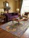 7' x 9' Rectangular Purple & Multicolor Medallion Distressed Traditional Area Rug styled in an elegant living room with sofa, armchair, and coffee table.