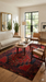 7' x 9' Rectangular Red & Black Tribal Geometric Traditional Area Rug styled in a modern living room with wood flooring and mid-century furniture.