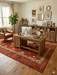 7' x 9' Rectangular Red Geometric Tribal Southwestern Area Rug styled in a home office with wood furniture and contemporary decor.