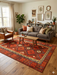 7' x 9' Rectangular Red Geometric Tribal Southwestern Area Rug styled in a living room with warm wood tones, neutral seating, and bohemian-inspired decor.