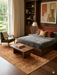 7' x 9' Rectangular Rust Gold Distressed Floral Medallion Vintage Traditional Area Rug styled in a bedroom with minimalist decor and natural light.