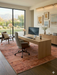 7' x 9' Rectangular Rust Terracotta Distressed Abstract Vintage Area Rug styled in a home office with modern wood furniture.
