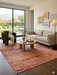7' x 9' Rectangular Rust Terracotta Distressed Abstract Vintage Area Rug styled in a living room with neutral seating and warm accents.