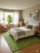 7' x 9' rectangular green textured micro dot modern area rug styled in a bedroom with a light upholstered bed, wooden furniture, and soft natural accents.
