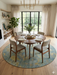 8' Round Blue & Gold Distressed Floral Traditional Washable Area Rug styled in a dining room with a round table, upholstered chairs, and soft neutral decor.