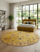 8' Round Gold Distressed Floral Medallion Vintage Traditional Area Rug styled in a bedroom.