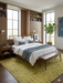 8' x 10' Rectangle Mustard Yellow & Light Blue Distressed Vintage Washable Area Rug placed in a modern bedroom beneath a wooden bed frame with built-in shelving and neutral bedding.