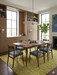 8' x 10' Rectangle Mustard Yellow & Light Blue Distressed Vintage Washable Area Rug styled in a dining room beneath a wooden dining table with upholstered chairs and warm modern décor.