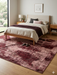8' x 10' Rectangular Blush & Burgundy Distressed Abstract Modern Area Rug styled in a bedroom with layered textiles and contemporary decor.