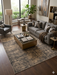 6' x 9' Rectangular Terracotta & Ivory Distressed Medallion Traditional Washable Area Rug styled in a bedroom with a bed and accent furniture.