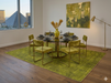 8' x 10' Rectangular Olive Gold Distressed Medallion Traditional Washable Area Rug featured in a contemporary dining room with a round glass table and olive green velvet chairs.