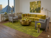 8' x 10' Rectangular Olive Gold Distressed Medallion Traditional Washable Area Rug styled in a contemporary living room with olive green velvet sofa, gray accent chairs, and brass coffee table.