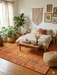 8' x 10' Rectangular Orange & Green Tree Motif Traditional Vintage Washable Area Rug styled in a cozy bohemian bedroom.
