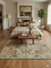 7' x 9' Rectangular Green & Beige Floral Traditional Washable Area Rug styled in a dining room with a wooden table, upholstered chairs, and warm lighting.