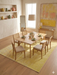 8' x 10' Rectangular Yellow Floral Distressed Traditional Area Rug featured in a bright dining room under a wooden dining table and chairs.