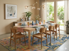 8' x 12' Rectangular Blue & Gold Abstract Modern Washable Area Rug styled in a bright dining room under a wooden dining table.