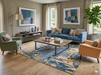 8' x 12' Rectangular Blue & Gold Abstract Modern Washable Area Rug styled in a contemporary living room.