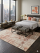 8' x 12' Rectangular Ivory Beige Distressed Abstract Modern Area Rug styled in a bedroom with city view.