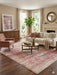 8' x 12' Rectangular Pink & Ivory Distressed Oriental Vintage Area Rug placed in a bright living room with neutral furniture and soft blush accents.