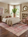 8' x 12' Rectangular Pink & Ivory Distressed Oriental Vintage Area Rug styled in a serene bedroom with cream bedding and elegant pink decor.