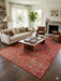 8' x 12' Rectangular Red & Black Tribal Geometric Traditional Area Rug styled in a living room with a sofa, armchairs, and a coffee table.