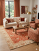 8' x 12' Rectangular Rust Orange & Ivory Floral Traditional Washable Area Rug styled in a living room with a sofa, coffee table, and accent chairs.