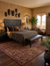 8' x 12' rectangular brown & tan animal print leopard pattern modern area rug placed in a cozy bedroom with a carved wood bed and neutral textiles.