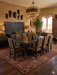 8' x 12' rectangular brown & tan animal print leopard pattern modern area rug styled in a warm dining room with wood furniture and earthy decor.