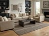 8' x 8' Square Ivory Charcoal Grid Modern Washable Area Rug styled in a contemporary living room with neutral furniture, dark shelving, and light wood floors.