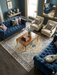 8' x 8' Square Ivory & Navy Blue Floral Medallion Traditional Area Rug placed in an elegant living room with tufted blue sofas and classic decor.